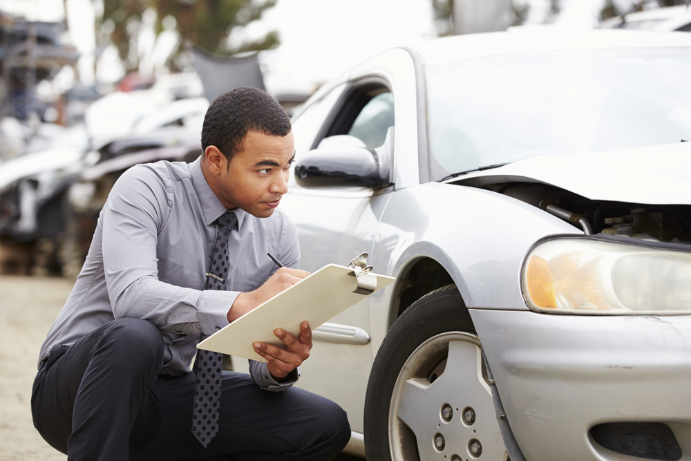 How Early Conversations With Insurance Adjusters Can Affect Your Santa Barbara Personal Injury Claim 1 Loss Adjuster Inspecting Car Involved In Accident